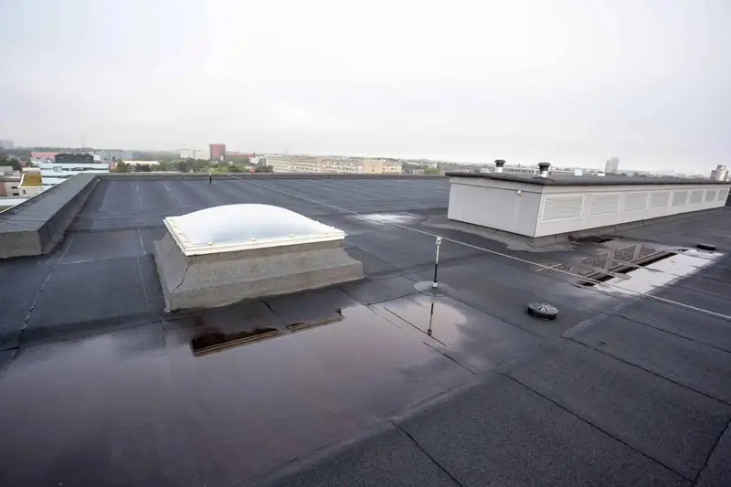 Rainwater lying in pools around a rooflight on a flat roof